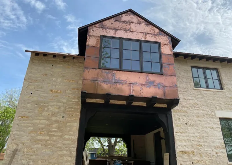 Copper metal panel facade on a stone building for Metal Roof Coating in New York