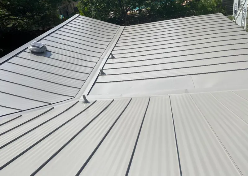 Solar attic fan installed on a metal roof for Roof Ventilation in New York